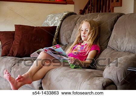 A girl, 5-10, reads a magazine View Large Photo Image Stock Image - A girl, 5-10, reads a magazine. Fotosearch