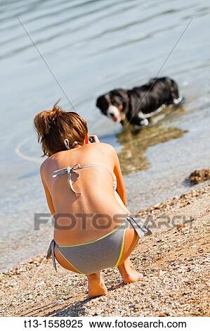 A girl and a dog on the beach View Large Photo Image Stock Photography - A girl and a dog on the beach. Fotosearch