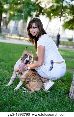 Stock Image - a girl and her dog outdoors. Fotosearch