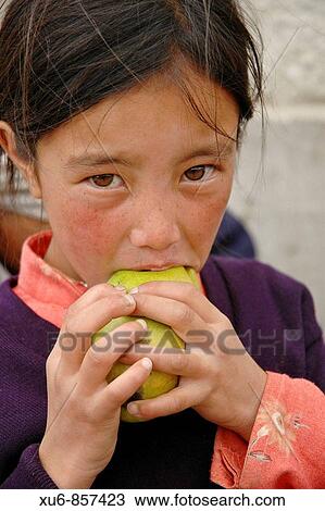 A girl eating a mango Leh, Ladakh, India View Large Photo Image Stock Image - A girl eating a mango Leh, Ladakh, India. Fotosearch