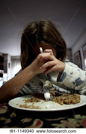 A girl eating View Large Photo Image Stock Image - A girl eating. Fotosearch