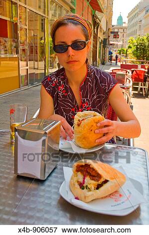 A girl having a schwarma sandwich at Maschu Maschu Israeli restaurant in Vienna Austria EU View Large Photo Image Stock Photo - A girl having a schwarma sandwich at Maschu Maschu Israeli restaurant in Vienna Austria EU. Fotosearch