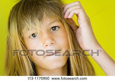 Stock Image - A girl is biting her lips. Fotosearch
