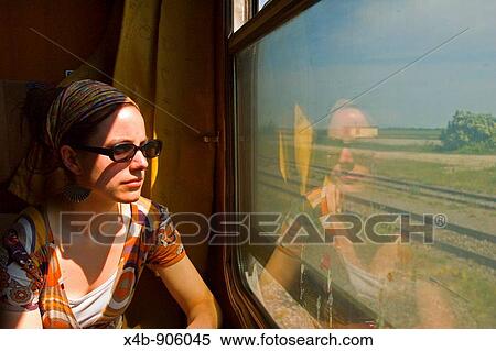 Stock Photography - A girl looking out of a train window in central Europe. Fotosearch