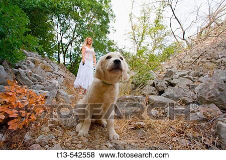 A girl with a pet dog in the woods View Large Photo Image Stock Photo - A girl with a pet dog in the woods. Fotosearch