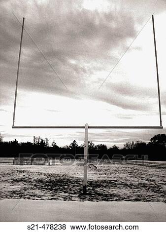 Stock Photo - A goalpost at a high school football in Upstate, New York is captured against a dramatic sky.. Fotosearch