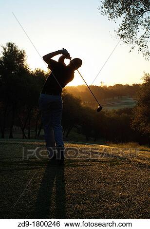 A golfer is silhouetted as he drives into the morning sun at Granite Bay Golf Club View Large Photo Image Stock Photograph - A golfer is silhouetted as he drives into the morning sun at Granite Bay Golf Club. Fotosearch