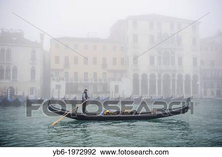A Gondola sails along the Grand canal of Venice covered with thick fog, Italy. View Large Photo Image Stock Image - A Gondola sails along the Grand canal of Venice covered with thick fog, Italy.. Fotosearch