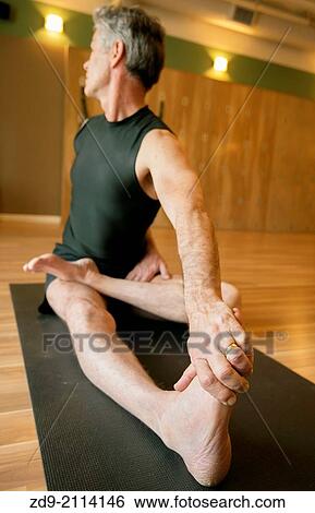 A gray-haired man demonstrates an ashtanga yoga pose. View Large Photo Image Stock Photograph - A gray-haired man demonstrates an ashtanga yoga pose.. Fotosearch