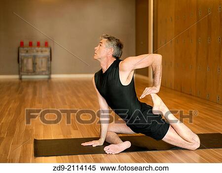 A gray-haired man demonstrates an ashtanga yoga pose. View Large Photo Image Stock Photography - A gray-haired man demonstrates an ashtanga yoga pose.. Fotosearch