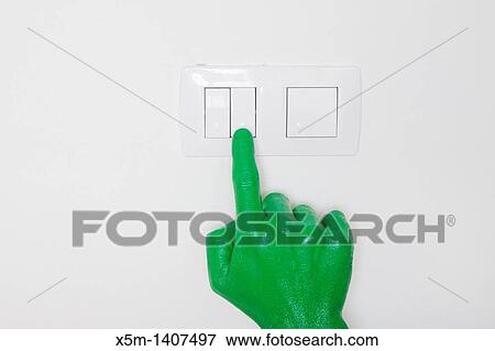 Stock Photo - A green hand switching on a light. Fotosearch