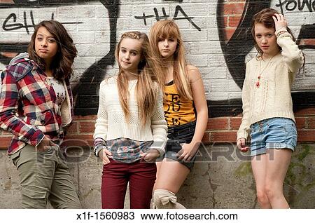A group of 13 year old teenage girls moody with attitude standing in front of a graffiti covered wall UK View Large Photo Image Stock Image - A group of 13 year old teenage girls moody with attitude standing in front of a graffiti covered wall UK. Fotosearch