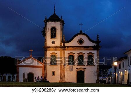A group of four senior tourists enjoying the nighfall at Paraty's oldest church, the Nossa Senhora dos Pardos Libertos (built 1722); Paraty, Espirito Santo, Brazil. The beautiful colonial town of Paraty has been a UNESCO World Heritage Site since 1958. View Large Photo Image Stock Photo - A group of four senior tourists enjoying the nighfall at Paraty's oldest church, the Nossa Senhora dos Pardos Libertos (built 1722); Paraty, Espirito Santo, Brazil. The beautiful colonial town of Paraty has been a UNESCO World Heritage Site since 1958.. Fotosearch