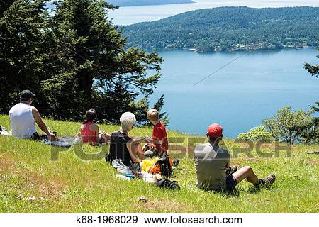 Stock Photo - A group of hikers enjoy the view from Mount Warburton Pike, a mountain on Saturna Island in the Gulf Islands of British Columbia, Canada.. Fotosearch