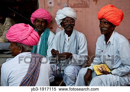 A group of men sit chatting on the street, Pushkar, Rajasthan, India View Large Photo Image Stock Photography - A group of men sit chatting on the street, Pushkar, Rajasthan, India. Fotosearch