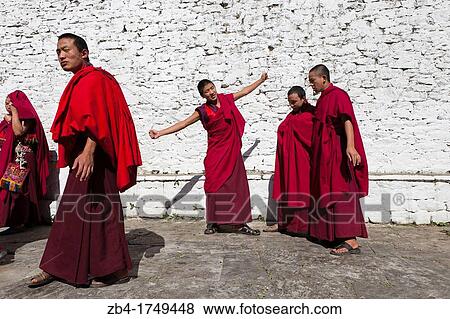Stock Photo - A group of monks in the patio of Trongsa Dzong, Trongsa, Bhutan, Asia.. Fotosearch