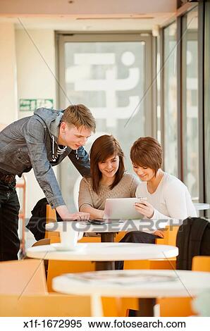 A group of young people - two girls and a boy - talking chatting in a cafe, UK View Large Photo Image Stock Photography - A group of young people - two girls and a boy - talking chatting in a cafe, UK. Fotosearch