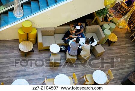 A group works together in a public space at a mall in Paris. View Large Photo Image Stock Photo - A group works together in a public space at a mall in Paris.. Fotosearch