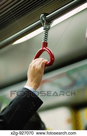 Stock Image - A hand of a businessman inside MTR in Hong Kong, HKSAR. Fotosearch