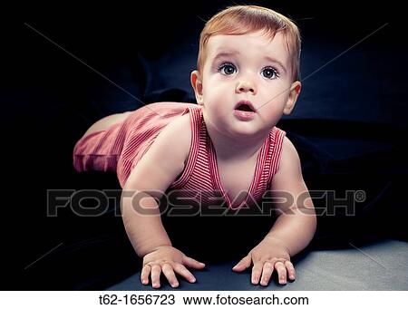 A handsome baby crawls and plays alone View Large Photo Image Stock Image - A handsome baby crawls and plays alone. Fotosearch