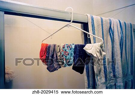 A hanger with dangling women's underwear in a bathroom next to a towel. View Large Photo Image Stock Photography - A hanger with dangling women's underwear in a bathroom next to a towel.. Fotosearch