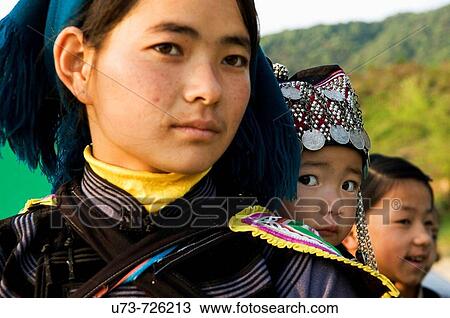 Stock Image - A Hani Akha woman with her baby. Fotosearch