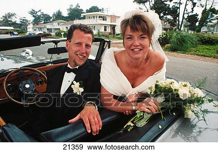 A happily wedded couple drives off to the future View Large Photo Image Stock Photo - A happily wedded couple drives off to the future. Fotosearch