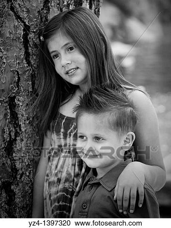 A happy brother and sister outdoors. View Large Photo Image Stock Image - A happy brother and sister outdoors.. Fotosearch
