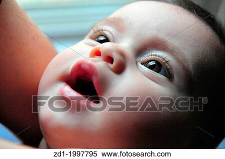 A happy contented baby looks into her mothers eyes. View Large Photo Image Stock Photography - A happy contented baby looks into her mothers eyes.. Fotosearch