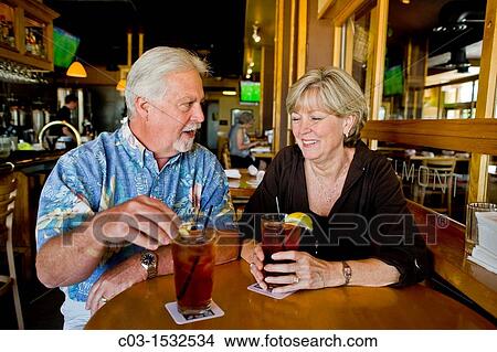 A happy middle aged married couple enjoy iced tea together in a Long Beach, CA, restaurant View Large Photo Image Picture - A happy middle aged married couple enjoy iced tea together in a Long Beach, CA, restaurant. Fotosearch