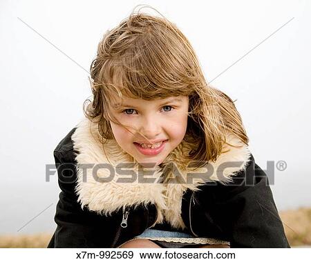 Stock Photo - A happy mixed race girl hispanic/latin & caucasian in cold weather. Fotosearch