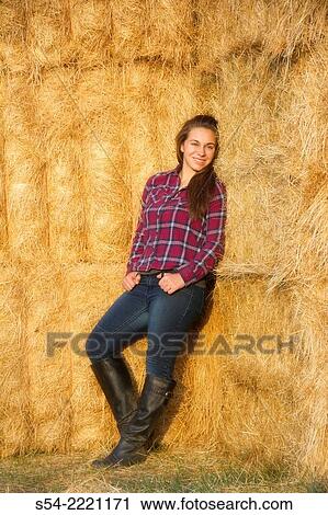 A happy teen girl leans against hay bales at a farm in Eastern Washington, USA. View Large Photo Image Stock Image - A happy teen girl leans against hay bales at a farm in Eastern Washington, USA.. Fotosearch