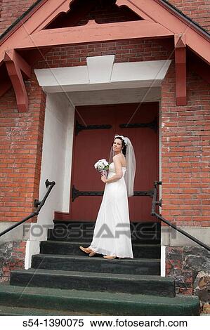 A happy woman in a bridal gown, standing by a church in Rosalia, Washington, USA. View Large Photo Image Stock Photography - A happy woman in a bridal gown, standing by a church in Rosalia, Washington, USA.. Fotosearch