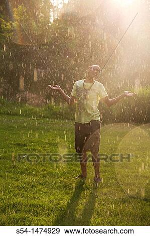 Stock Photo - A happy, young, african-american male outdoors. Fotosearch