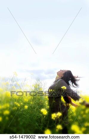 A happy young caucasian woman in a field of canola View Large Photo Image Stock Image - A happy young caucasian woman in a field of canola. Fotosearch