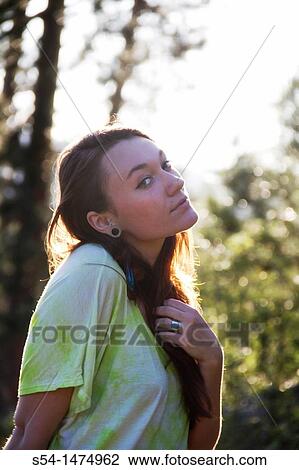 A happy young caucasian woman outdoors View Large Photo Image Stock Image - A happy young caucasian woman outdoors. Fotosearch