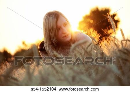 A happy young woman in a field of barley in Lewiston, Idaho, USA. View Large Photo Image Picture - A happy young woman in a field of barley in Lewiston, Idaho, USA.. Fotosearch