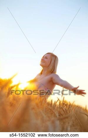 A happy young woman in a field of barley in Lewiston, Idaho, USA. View Large Photo Image Stock Image - A happy young woman in a field of barley in Lewiston, Idaho, USA.. Fotosearch