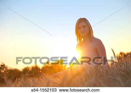 A happy young woman in a field of barley in Lewiston, Idaho, USA. View Large Photo Image Stock Image - A happy young woman in a field of barley in Lewiston, Idaho, USA.. Fotosearch