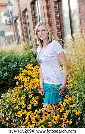 A happy young woman in a garden of Black-eyed Susan flowers, Lewiston, Idaho, USA. View Large Photo Image Picture - A happy young woman in a garden of Black-eyed Susan flowers, Lewiston, Idaho, USA.. Fotosearch