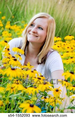A happy young woman in a garden on Black-eyed Susan flowers, Lewiston, Idaho, USA. View Large Photo Image Stock Image - A happy young woman in a garden on Black-eyed Susan flowers, Lewiston, Idaho, USA.. Fotosearch