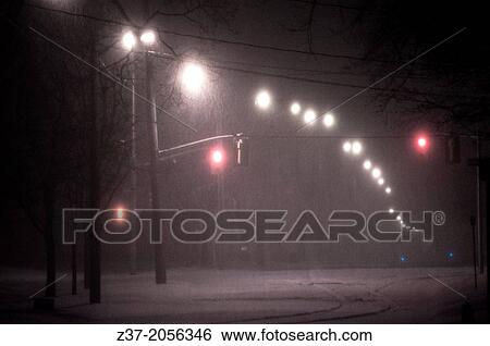 Stock Photograph - A heavy snow storm blankets a modern city, Ontario, Canada. Fotosearch