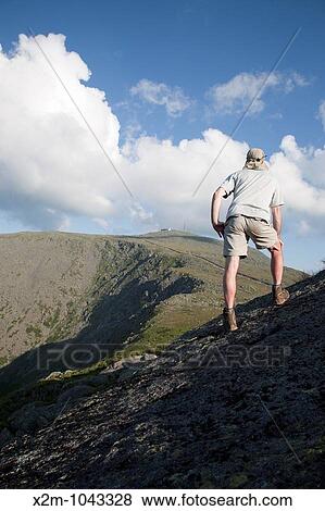 A hiker enjoys the view of Mount Washington at sunset from Mount Clay Located in the White Mountains, New Hampshire USA Notes: Mount Washington is famous for the highest wind gust ever measured on earth at 231 miles per hour on April 12, 1934 View Large Photo Image Stock Photo - A hiker enjoys the view of Mount Washington at sunset from Mount Clay Located in the White Mountains, New Hampshire USA Notes: Mount Washington is famous for the highest wind gust ever measured on earth at 231 miles per hour on April 12, 1934. Fotosearch