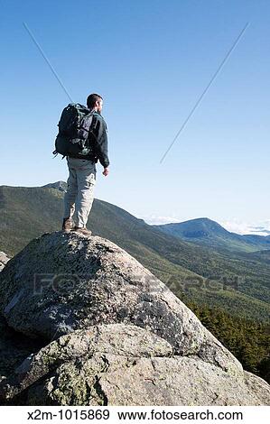 A hiker enjoys the views of the Pemigewasset Wilderness from the summit of Mount Liberty during the summer months Located in the White Mountains, New Hampshire USA View Large Photo Image Stock Photo - A hiker enjoys the views of the Pemigewasset Wilderness from the summit of Mount Liberty during the summer months Located in the White Mountains, New Hampshire USA. Fotosearch