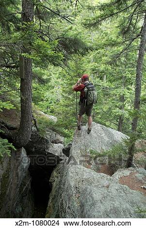 A hiker explores the Bear Pit on the side of Howker Ridge Trail on his way to Mount Madison during the summer months in the scenic landscape of the Northern Presidential Range Located in the White Mountains, New Hampshire USA View Large Photo Image Picture - A hiker explores the Bear Pit on the side of Howker Ridge Trail on his way to Mount Madison during the summer months in the scenic landscape of the Northern Presidential Range Located in the White Mountains, New Hampshire USA. Fotosearch
