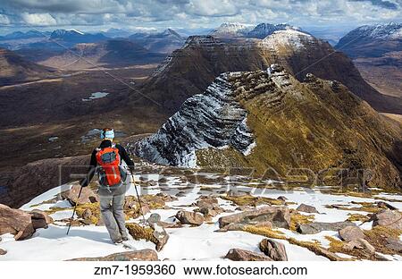 A hiker heading down Ben Alligin in the bright sun towards the three horns on the that are in still in the shade of the clouds. View Large Photo Image Stock Image - A hiker heading down Ben Alligin in the bright sun towards the three horns on the that are in still in the shade of the clouds.. Fotosearch