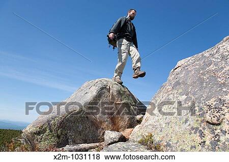 Stock Photo - A hiker on Middle Sister Trail near Mount Chocorua during the spring months Located in the White Mountains, New Hampshire USA. Fotosearch