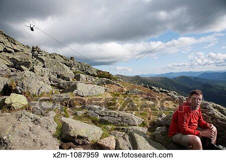 Stock Photo - A hiker on the Appalachian Trail near Mount Clay during the summer months Located in the White Mountains, New Hampshire USA. Fotosearch