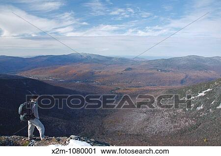 A hiker on the summit of Mount Flume in the White Mountains, New Hampshire USA View Large Photo Image Stock Image - A hiker on the summit of Mount Flume in the White Mountains, New Hampshire USA. Fotosearch