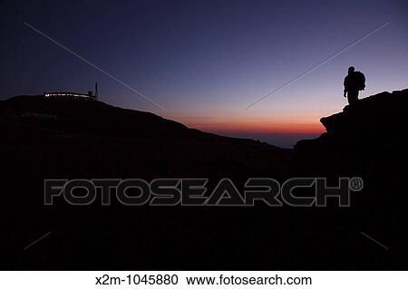 A hiker takes in the view of Mount Washington at sunset from Ball Crag Located in the White Mountains, New Hampshire USA Notes: Mount Washington is famous for the highest wind gust ever measured on earth at 231 miles per hour on April 12, 1934 View Large Photo Image Stock Image - A hiker takes in the view of Mount Washington at sunset from Ball Crag Located in the White Mountains, New Hampshire USA Notes: Mount Washington is famous for the highest wind gust ever measured on earth at 231 miles per hour on April 12, 1934. Fotosearch